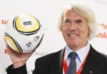 Dvorak, Chief Medical Officer of FIFA poses for photographers as he presents a ball during news conference in Crans Montana